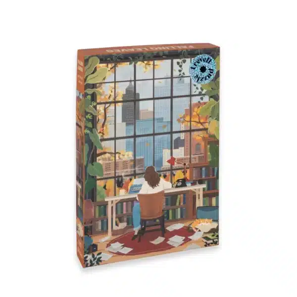 Puzzle Falling Leaves Trevell – 500 pièces, illustration d’une jeune fille assise à son bureau écrivant près d’une fenêtre avec vue sur la ville aux couleurs d’automne.